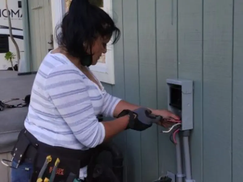 Licensed electrician wiring an exterior subpanel in Davie