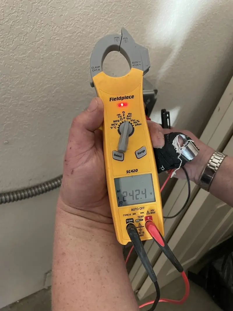 Voltage testing with clamp meter during Outlet Installation in Davie